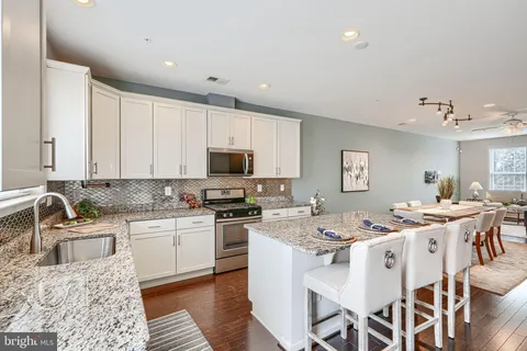 a large kitchen with lots of counter space and stainless steel appliances