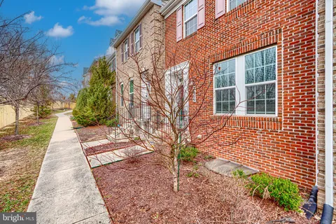 a pathway of a house with a yard