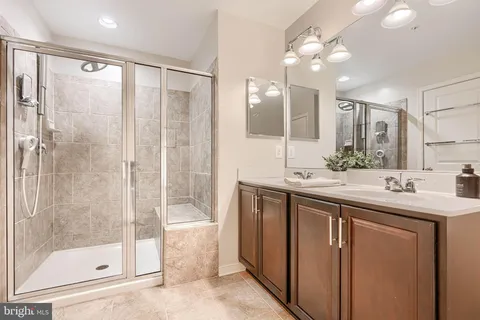 a bathroom with a granite countertop toilet sink and a mirror