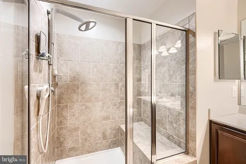 a bathroom with a double vanity sink mirror and shower