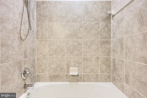 a bathroom with a granite countertop sink toilet a shower and a mirror