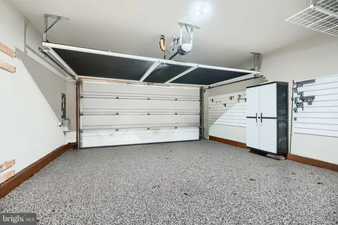 a bathroom with a granite countertop bathtub shower sink vanity and toilet