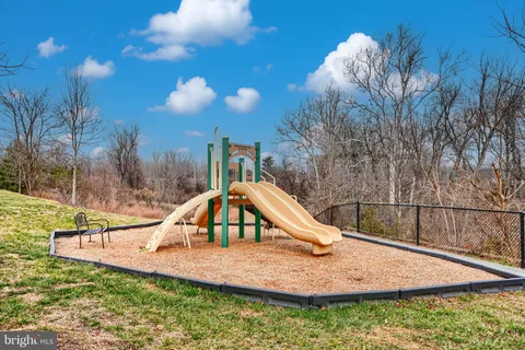 a street sign on a sidewalk next to a building