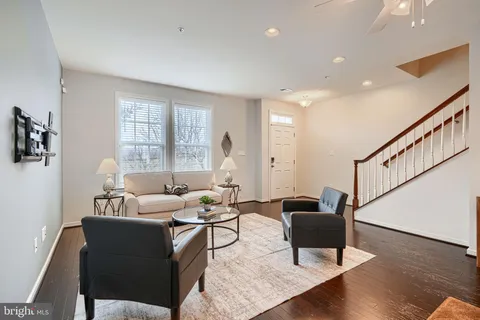 a living room with furniture kitchen view and a dining table