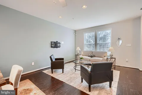 a living room with furniture rug and window