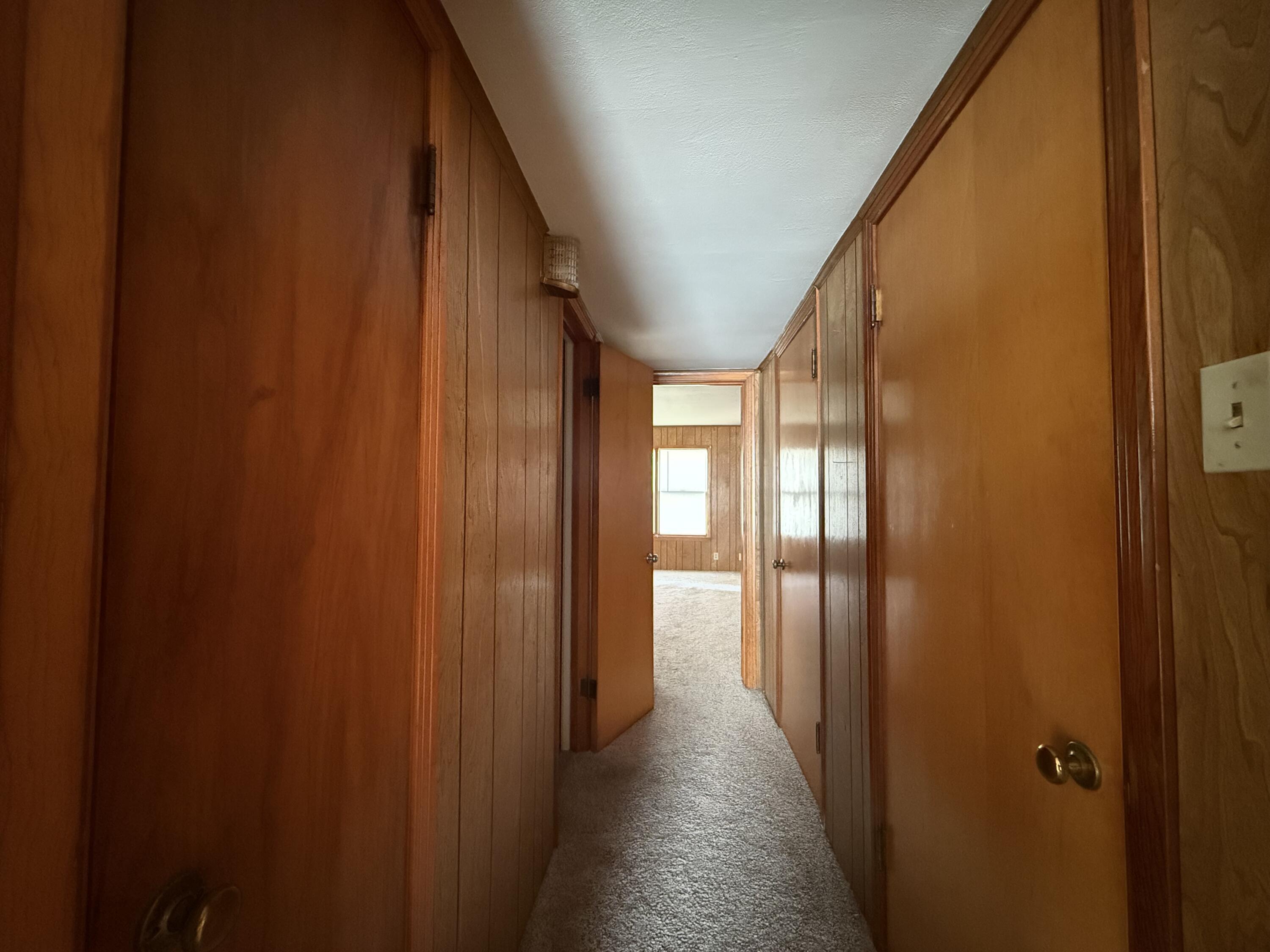 715 West Davis Street Memphis, TX 79245 - Photo 9 of 11 a view of a hallway with wooden floor and staircase