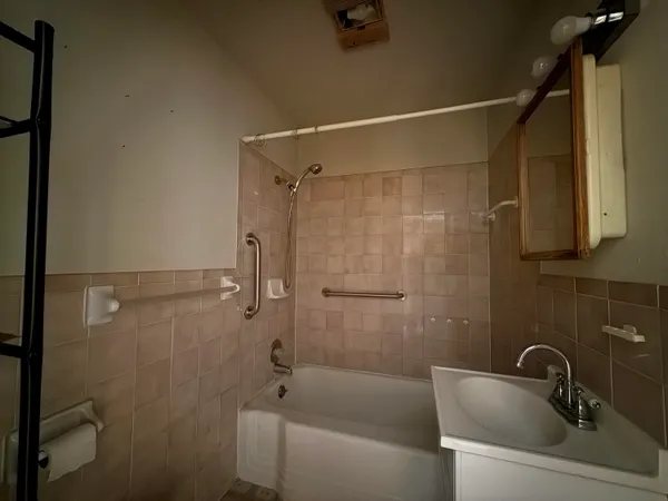 a bathroom with a sink and shower