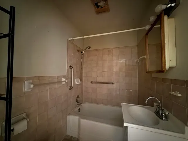 a bathroom with a sink and shower