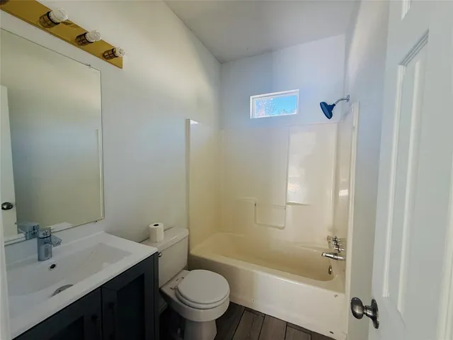 a bathroom with a sink mirror toilet and bathtub