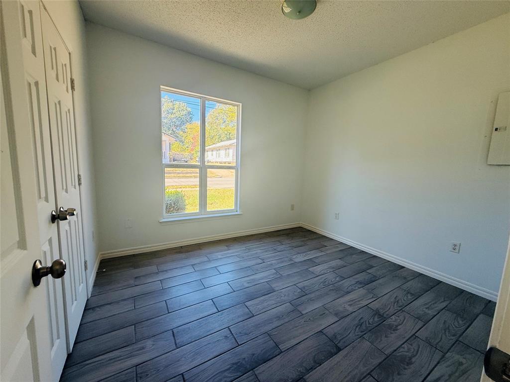 255 7th Street Southwest Paris, TX 75460 - Photo 12 of 17 a view of a room with wooden floor and a window