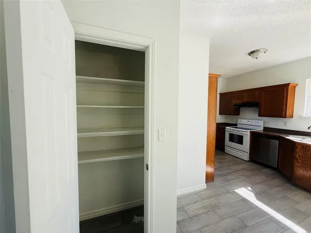 a view of a kitchen with a sink and dishwasher oven dryer