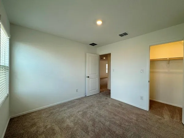 an empty room with closet area