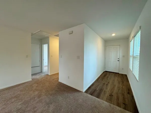 a view of hallway with wooden floor