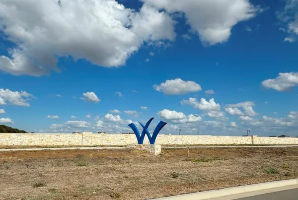 a view of a backyard with wooden fence