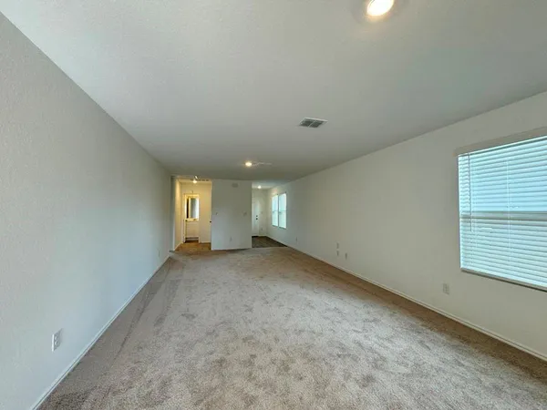 an empty room with a window and a fireplace