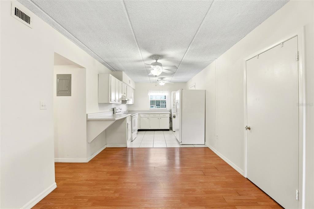 525 South Conway Road, Unit 69 Orlando, FL 32807 - Photo 11 of 25 a view of a kitchen with a sink and dishwasher with wooden floor