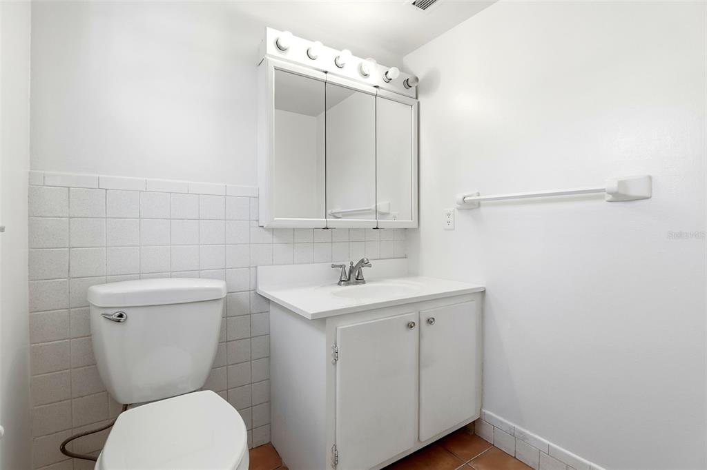 525 South Conway Road, Unit 69 Orlando, FL 32807 - Photo 20 of 25 a bathroom with a toilet a sink and a mirror