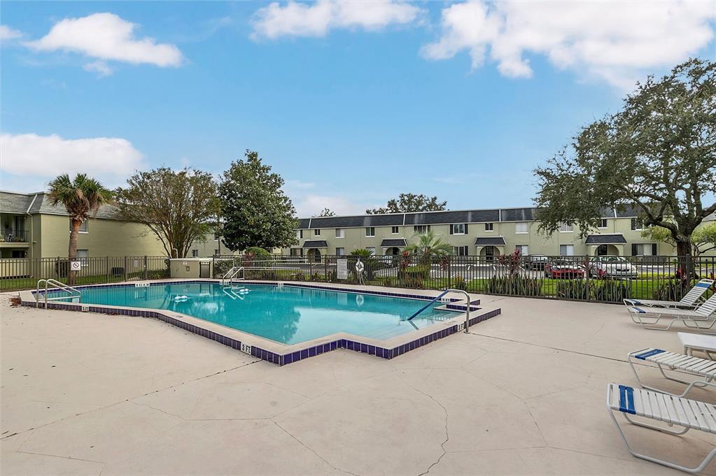 525 South Conway Road, Unit 69 Orlando, FL 32807 - Photo 23 of 25 a view of swimming pool outdoor seating and lake view