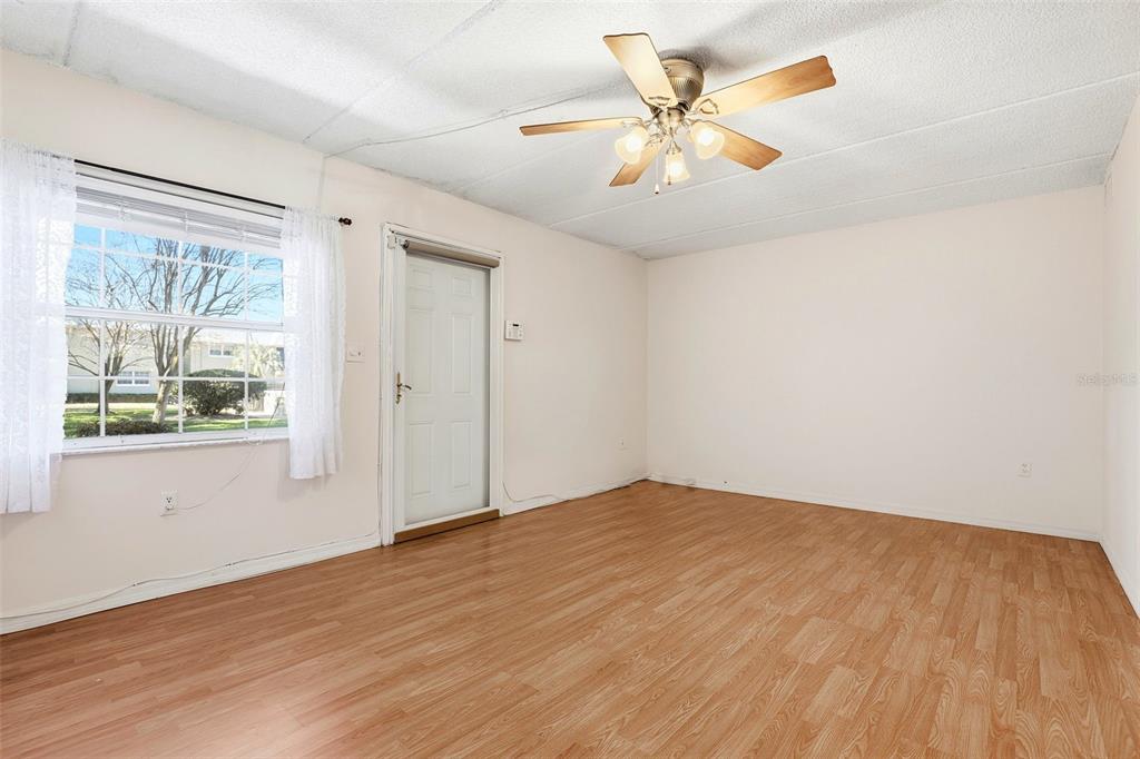 525 South Conway Road, Unit 69 Orlando, FL 32807 - Photo 9 of 25 an empty room with wooden floor and windows