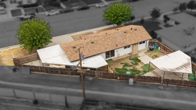 an aerial view of a house with outdoor space