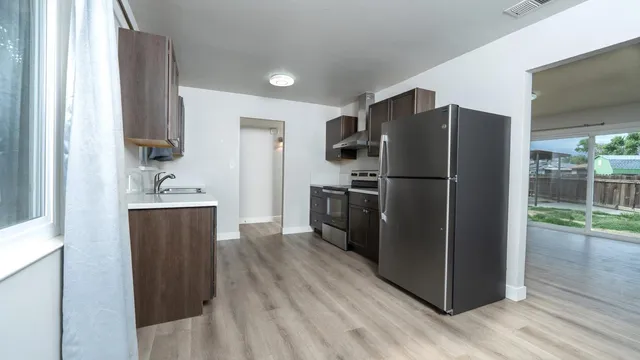 a kitchen with a refrigerator and a sink