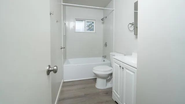 a bathroom with a toilet and a shower