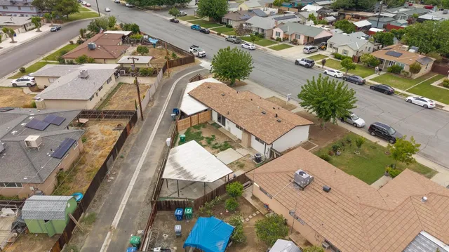 an aerial view of a residential houses with outdoor space