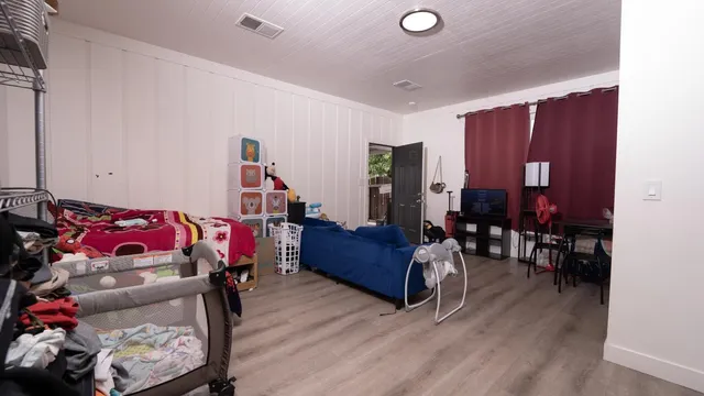 a bedroom with furniture and a wooden floor