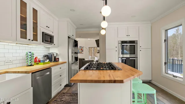 a kitchen that has a lot of cabinets and appliances