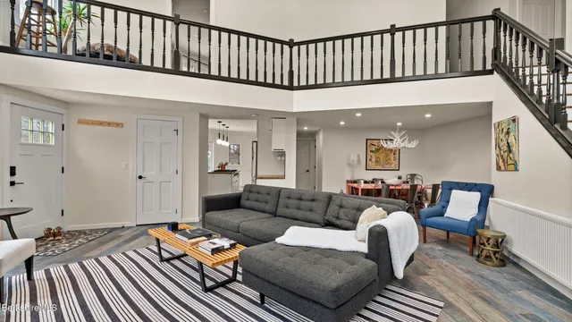 a living room with furniture a wooden floor and a rug