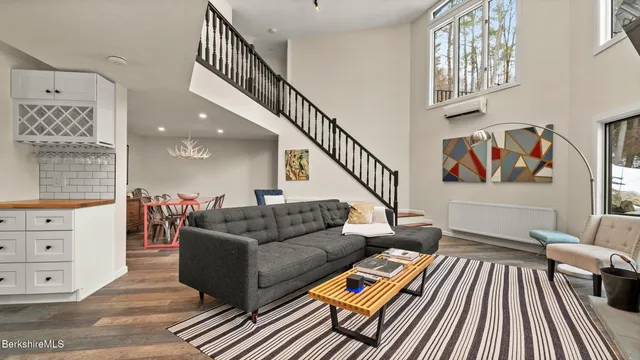 a living room with furniture and a ceiling fan