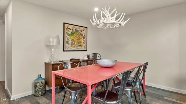 a view of a dining room with furniture and chandelier
