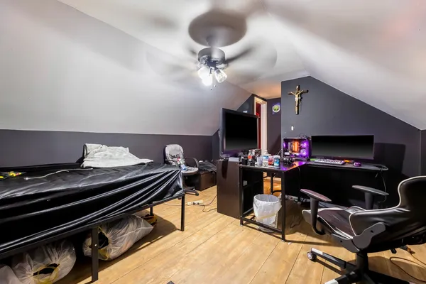a work room with furniture and ceiling fan