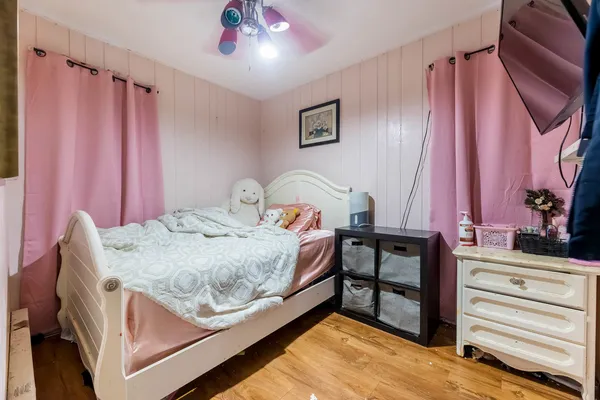a bedroom with a bed and a chandelier