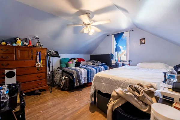 a bedroom with a bed and a chandelier