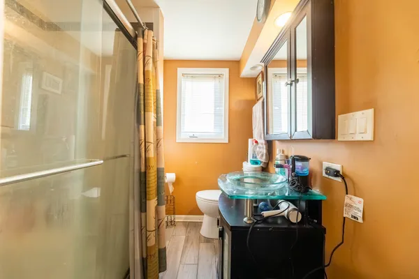 a bathroom with a sink a mirror and a shower