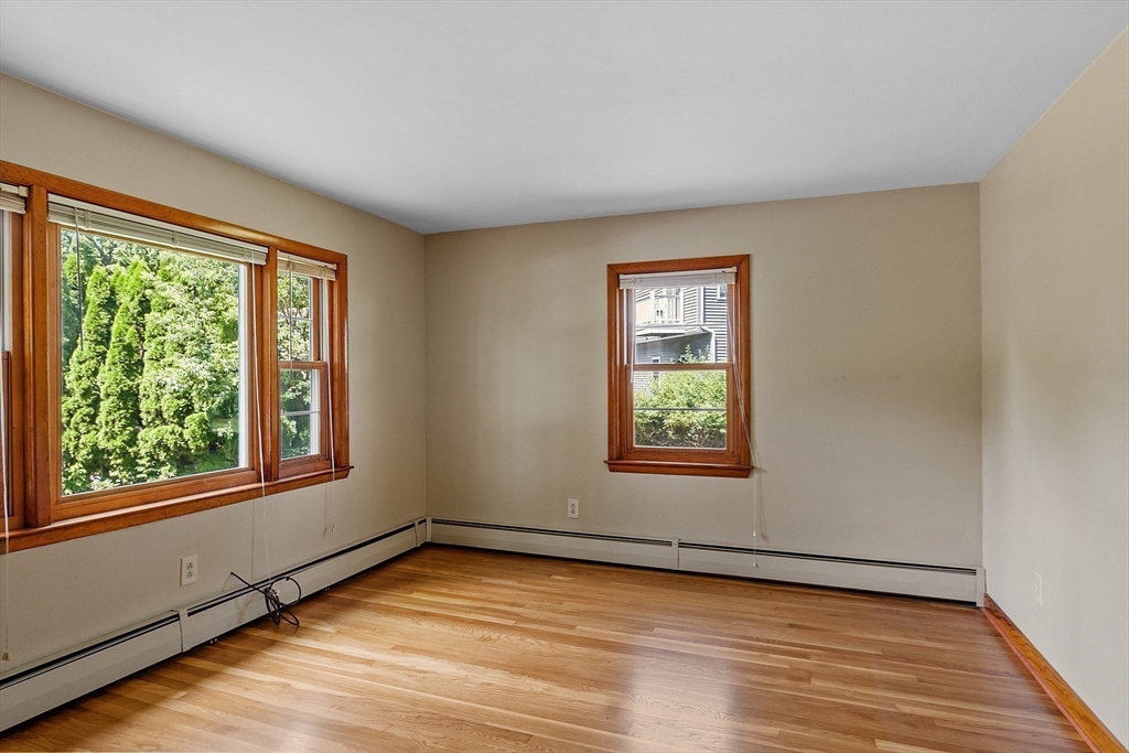 14 Meade Road Waltham, MA 02451 - Photo 11 of 29 a view of an empty room with wooden floor and a window