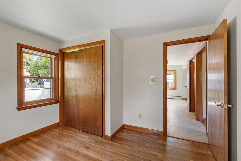 14 Meade Road Waltham, MA 02451 - Photo 13 of 29 an empty room with wooden floor mirror and windows