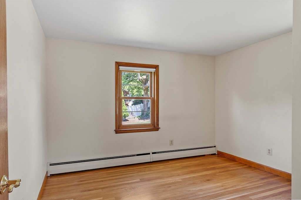14 Meade Road Waltham, MA 02451 - Photo 14 of 29 a view of an empty room with wooden floor and a window