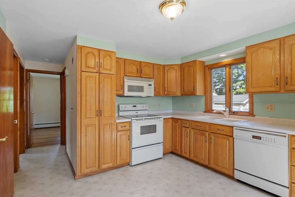 14 Meade Road Waltham, MA 02451 - Photo 4 of 29 a kitchen with stainless steel appliances granite countertop a stove a sink and a refrigerator