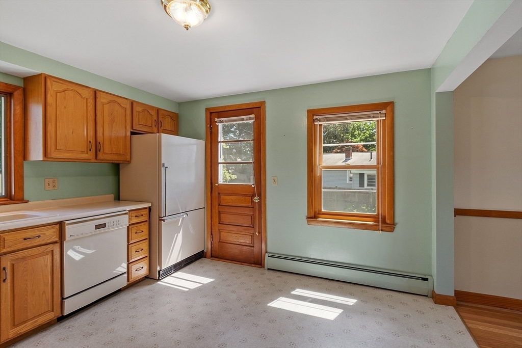 14 Meade Road Waltham, MA 02451 - Photo 5 of 29 a kitchen with stainless steel appliances granite countertop a refrigerator and a stove top oven