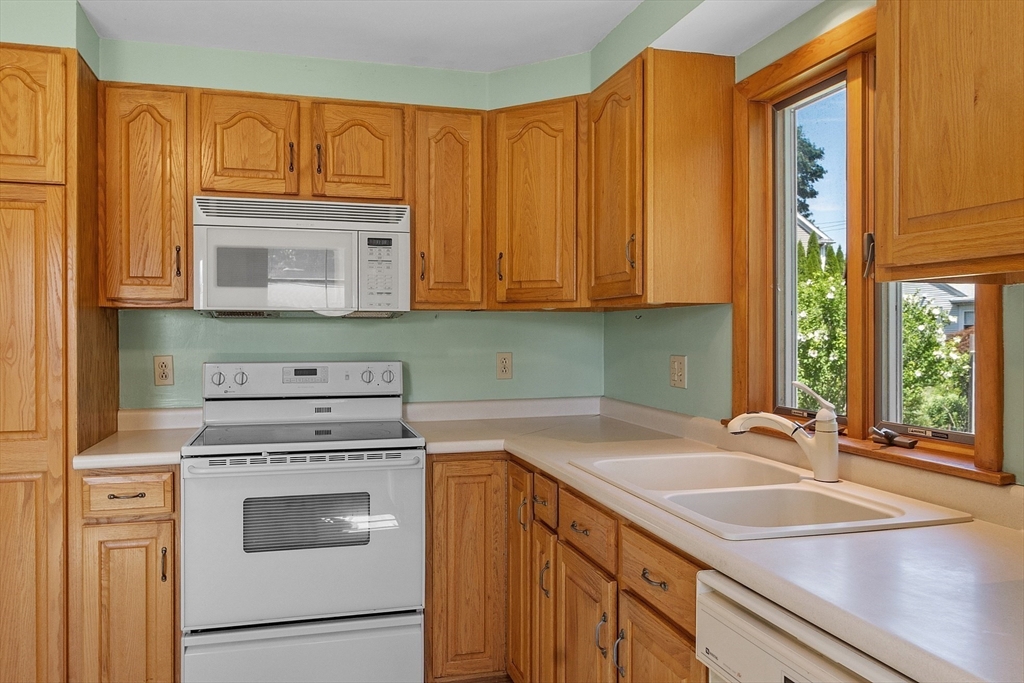14 Meade Road Waltham, MA 02451 - Photo 6 of 29 a kitchen with a sink stove and cabinets