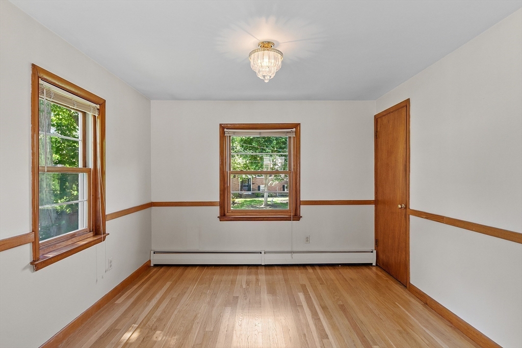 14 Meade Road Waltham, MA 02451 - Photo 8 of 29 a view of an empty room with wooden floor and a window
