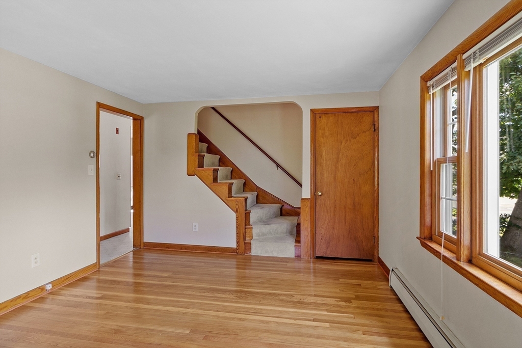 14 Meade Road Waltham, MA 02451 - Photo 9 of 29 a view of entryway with wooden floor and stairs