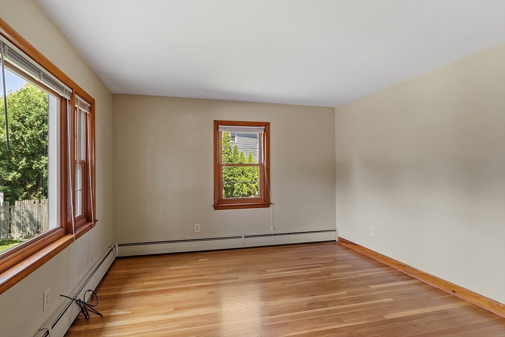14 Meade Road Waltham, MA 02451 - Photo 10 of 29 an empty room with wooden floor and windows