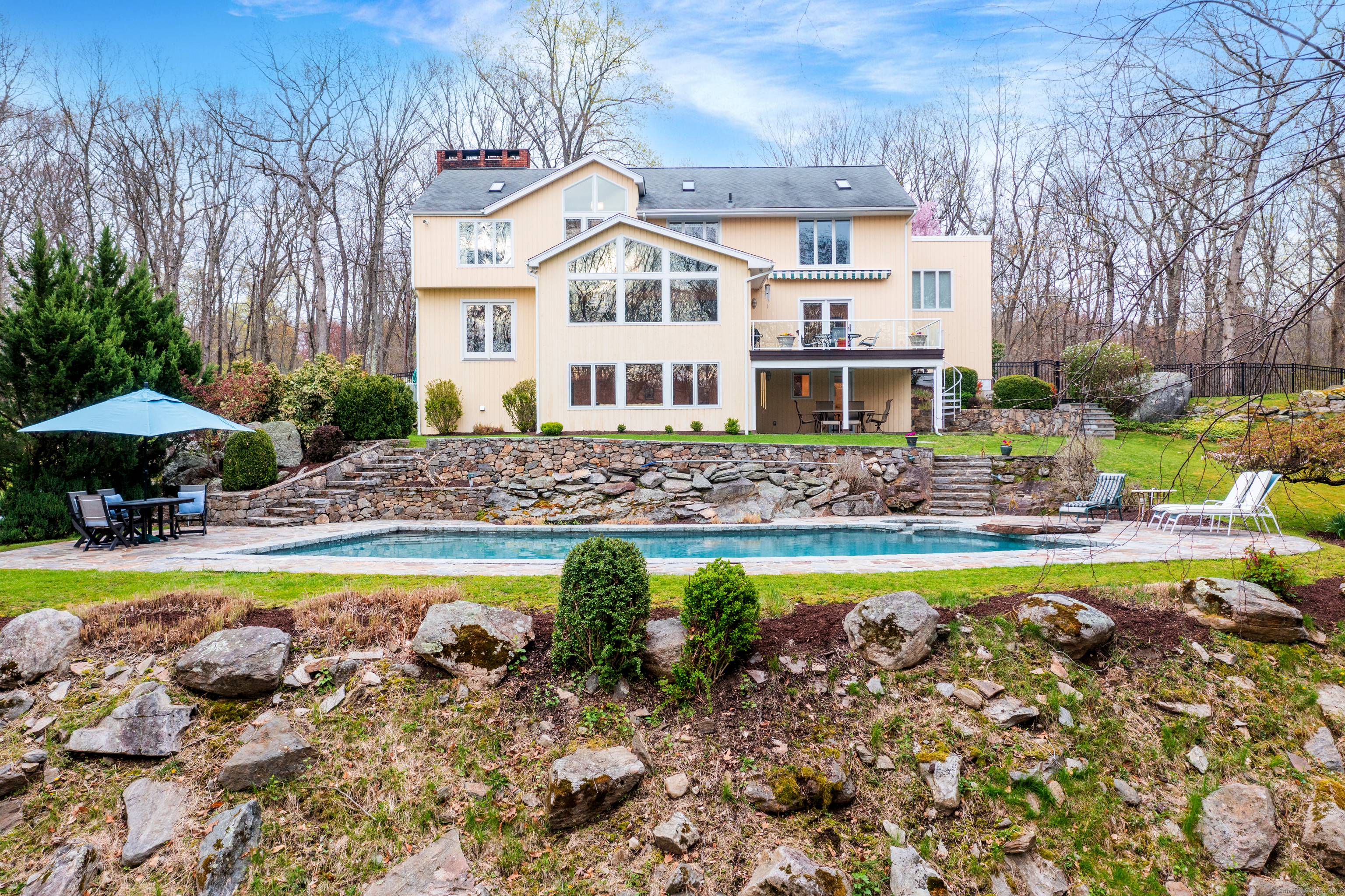 Come visit this custom built contemporary (with a traditional elegant flair) and its beautiful outdoor setting including a hot tub & 50 ft in-ground heated Gunite pool!