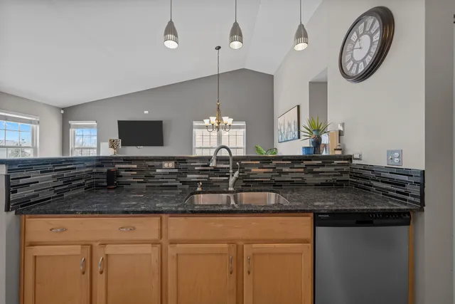 a kitchen with a sink and a stove top oven