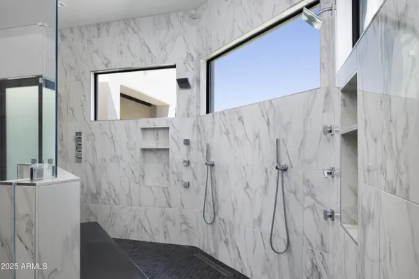 a bathroom with a sink a mirror and a shower