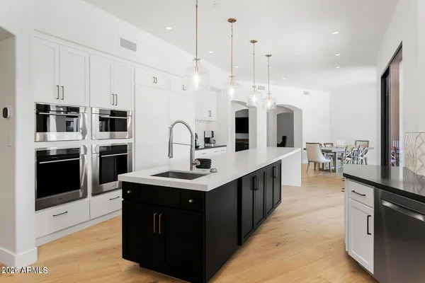 a spacious bathroom with a double vanity sink a mirror and a shower