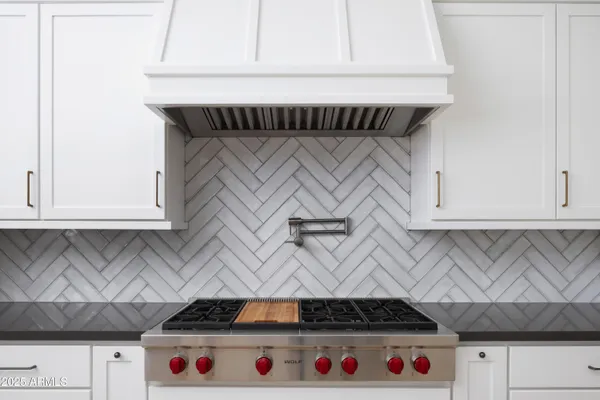 a kitchen with stainless steel appliances a sink stove and refrigerator